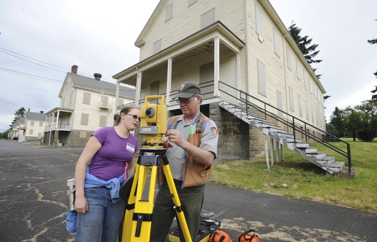 Setting up surveying equipment to set up a dig at the site of the 1854 Army flagstaff at Vancouver Barracks