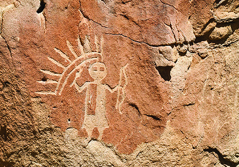 Petroglyph in northern New Mexico shows an anthropomorphic figure with headdress and recurved bow. It is believed that the image was carved sometime between 16th and 18th centuries.