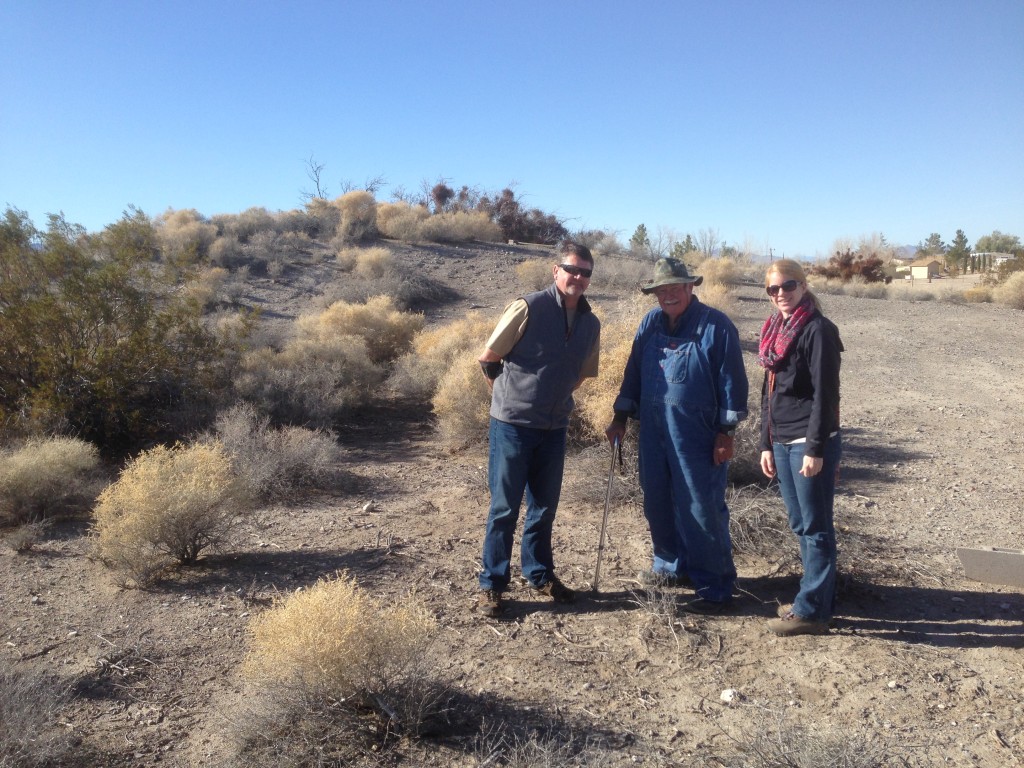 The mound in the background and Western Regional Director Cory Wilkins on the left, avocational archaeologists Don Hendricks in the middle, and Western Field Representative Deanna Commons on the right.