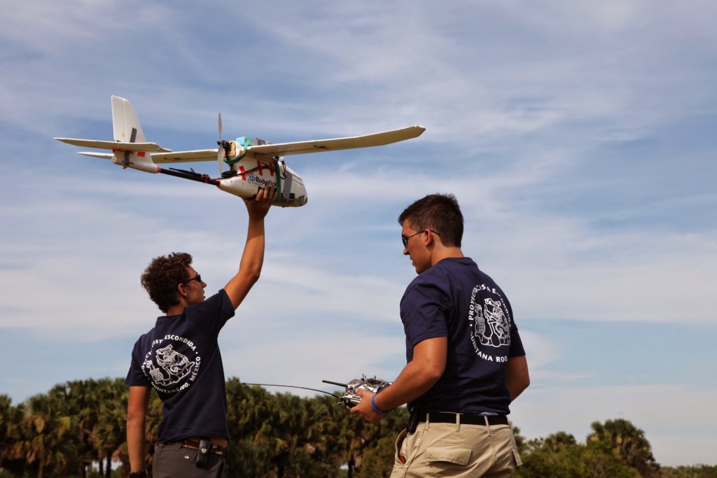 Dominique Meyer and Sebastian Afshari prepare to hand-launch a fixed-wing drone for an extended survey mission over the north coastal region of Quintana Roo, Mexico. credit: Vera Smirnov, CISA3, UC San Diego