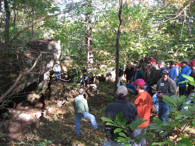 Eastern Regional Director Andy Stout explains the excavations that took place in the Rock Shelter seen in the left of the photo.