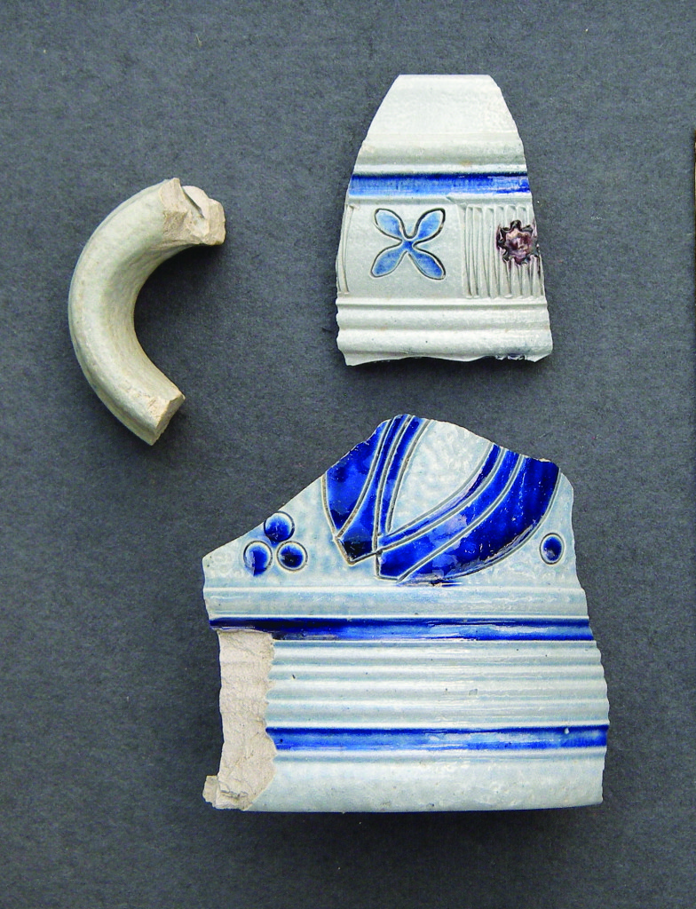 These fragments of German stoneware tankards were discovered in the stone-walled cellar. They date to the early-to-mid 1700s.Credit: Neill De Paoli .