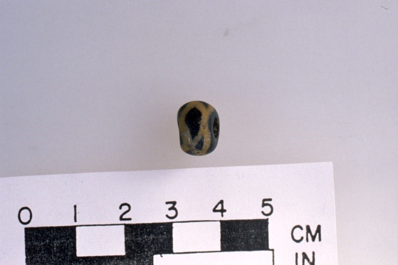 A glass bead and French gunflint recovered from the site help date deposits to European contact. Photo credit Jane Eastman.