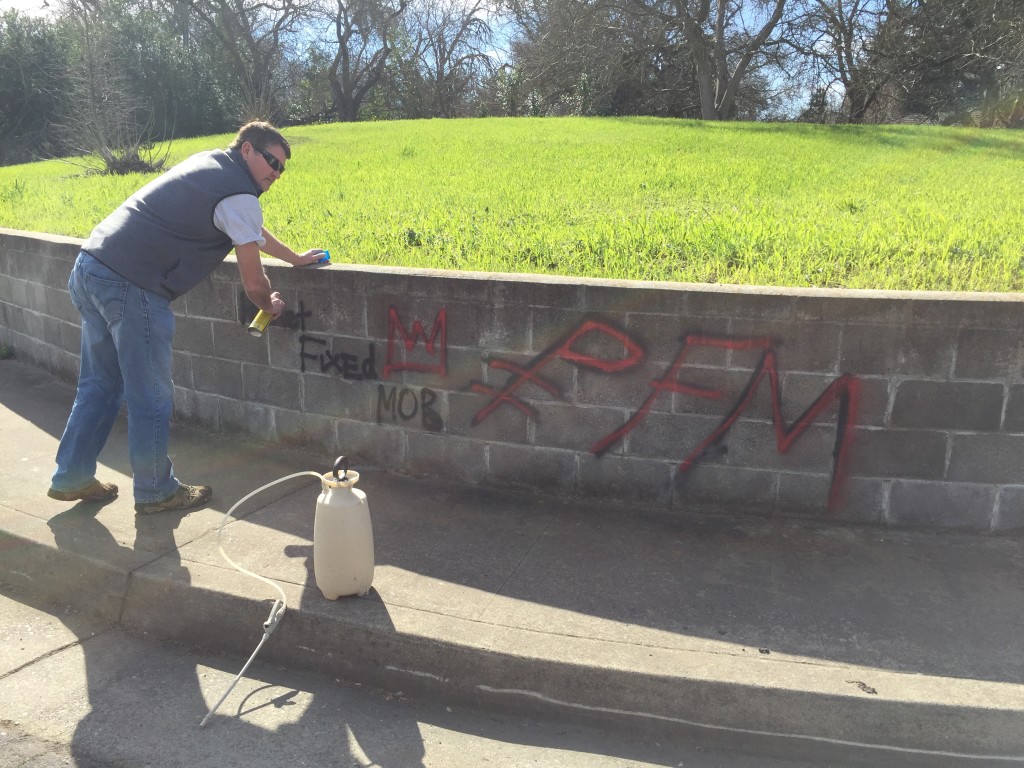 Cory Wilkins, Western Regional Director, working hard at removing the graffiti