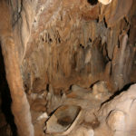 A large granite metate sits in the Metate Chamber in Actun Tunichil Muknal Cave. Credit: Jaime Awe
