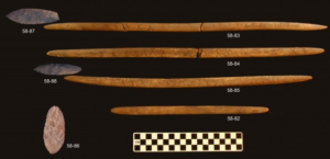 Stone projectile points and associated decorated antler foreshafts were found in the burial pit at the Upward Sun River site. Credit: Ben Potter.