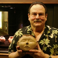 Dr. Jeffrey M. Mitchem holding an Arkansas headpot. Photo courtesy Arkansas Archeological Survey.
