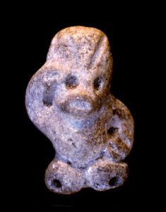 This human-like figure appears to be saluting. The mouthpiece is in his head and two of the tone-holes are in his feet. Credit: Photo by Norman Hammond, copyright Cuello Project.