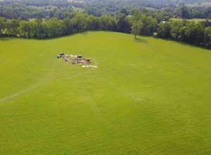 This aerial shot of the 2017 excavations was taken with a drone. The mound is in the right foreground. Credit: JC Burns.