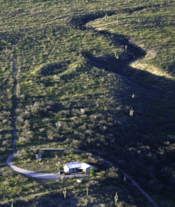 A large ballcourt is seen (center) near a house at the Redington site in the lower San Pedro Valley east of Tucson. This is ballcourt is located at the center of the lower San Pedro system of large courts. Credit: Henry D. Wallace, courtesy Archaeology Southwest