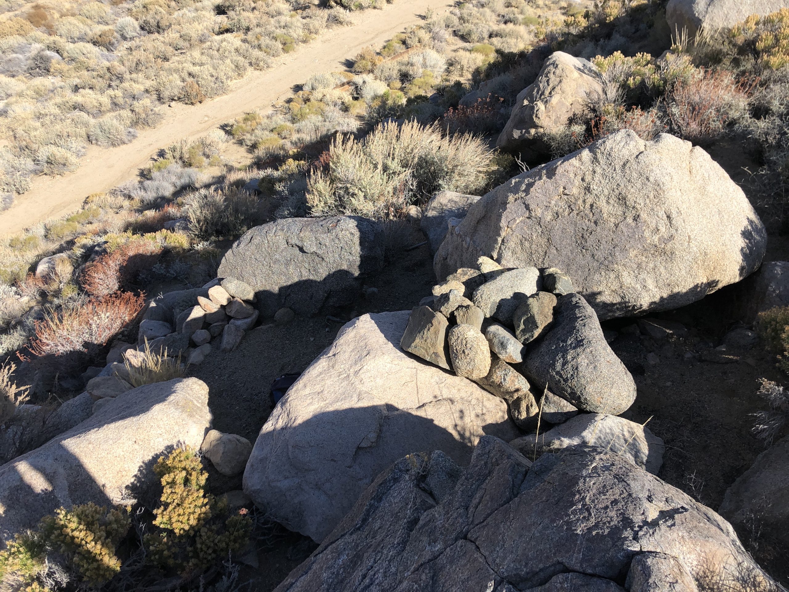 photo of large boulders with stacks of smaller rocks on top