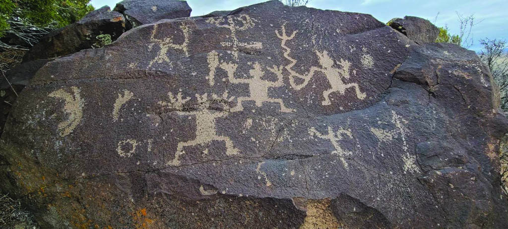 Photo of rock covered with petroglyphs.