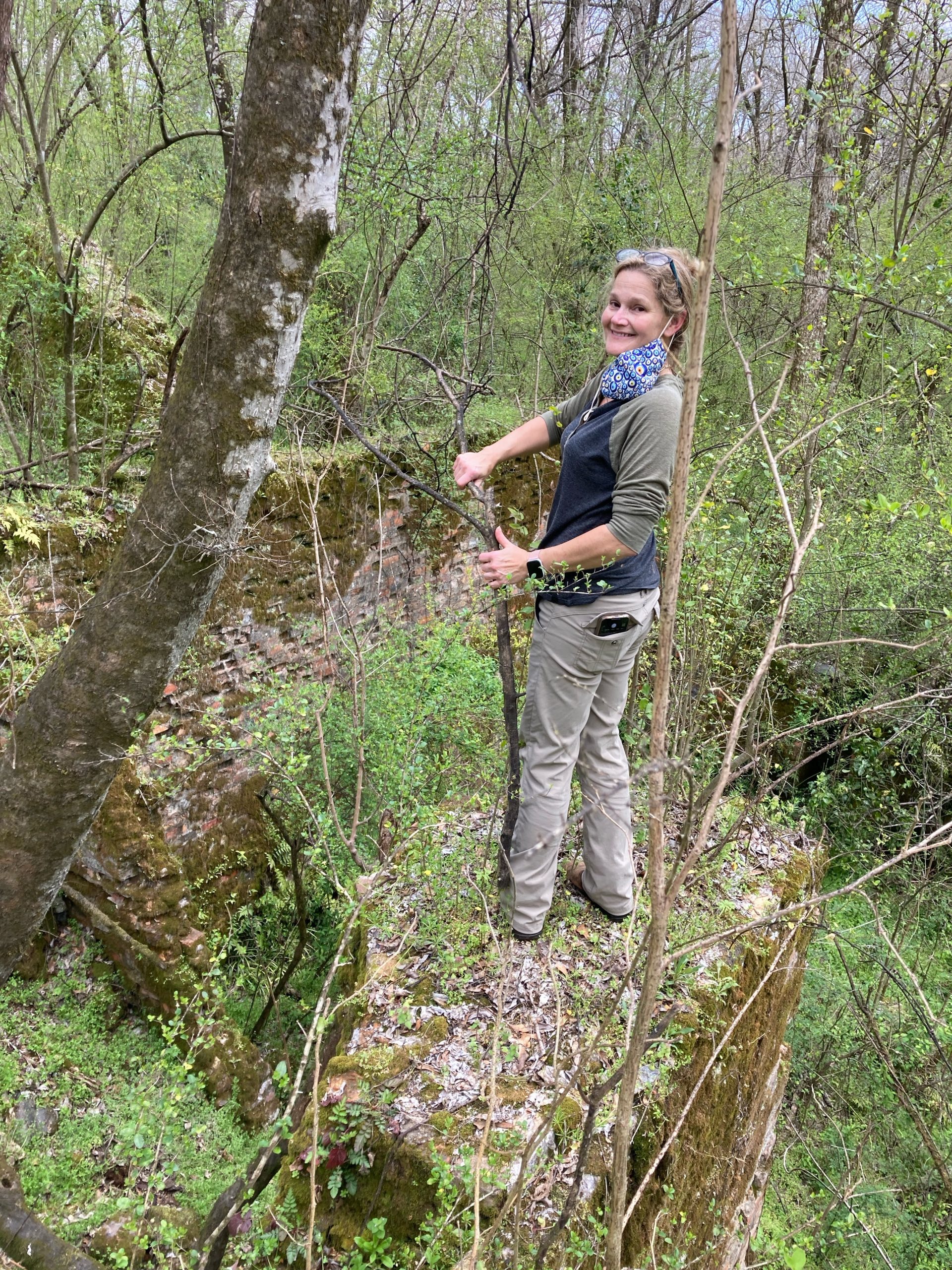 photo of woman standing in a wooded area